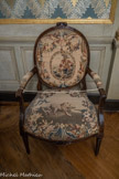 <center>Appartement ancien régime. Antichambre.</center>Fauteuil à la reine. 
Attribués à Pierre-Nicolas Pillot (1748-1822), menuisier, Nîmes, vers 1780.
Noyer, tapisserie d'Aubusson. Le mobilier est garni de tapisseries d’Aubusson. Chaque dossier représente une scène bucolique qu'entoure un médaillon à couronne de laurier enrubanné. Les assises sont décorées de fables de l'écrivain grec Ésope (7e- 6e siècles av. J.-C.) et de Jean de La Fontaine (1621-1695), à l’image de la grenouille qui veut se faire aussi grosse que le bœuf ou le lion et le rat (photo). Cet ensemble a intégré les collections du château de Grignan en 1987.