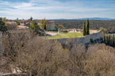 <center> Lussan.</center>La place du foirail. Au  XIIe siècle, le premier château, dont il reste des parties de muraille, est construit par les seigneurs de Lussan, alliés à la famille de Barjac, elle-même rattachée au Comté de Toulouse. Dégradé lors de la révolte des Tuchins entre 1381 et 1384, il est réparé puis abandonné au XVe siècle, période durant laquelle Marquèze de Barjac teste en faveur de son petit-fils Jacques d'Audibert. Cette famille d'Audibert va devenir l'une des plus puissantes de cette région pendant 3 siècles. Ils construisent à la fin du  XVe siècle, sur le plateau, un nouveau château, abritant actuellement la Mairie, et même une cinquantaine d'années plus tard un troisième, plus confortable avec un parc, face à la source de Fan. 
Cette famille, alliée aux Montmorency, voit au XVIIème siècle, sa seigneurie érigée en Comté. Marie Gabrielle de Lussan, fille unique du comte Jean d'Audibert épouse en 1700, Henry de Fitz-James, duc d'Albemarle, fils naturel de Jacques II Stuart, Roi d'Angleterre. Celui-ci étant décédé en 1702, elle épousera en 1707 Jean Drummond, duc de Melfort dont la dynastie restera sur Lussan jusqu'à la révolution de 1789 avant d'émigrer en Angleterre.